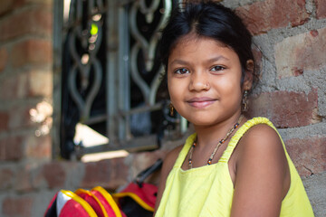 portrait of cute indian girl smiling and looking at camera