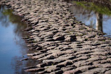 COBBLESTONE - Old stone road flooded by rain