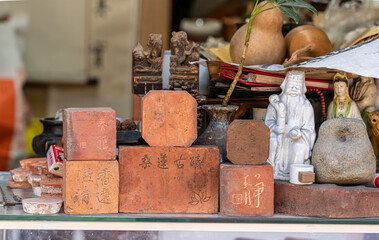 Coasters made of piles of clay with patterns and symbols engraved on them