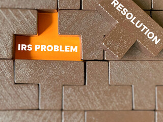 IRS Problem Resolution text with puzzle block background. Stock photo.