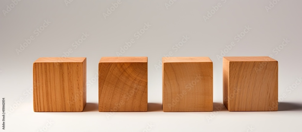 Poster Four identical wooden cubes are arranged on a white background positioned both in a row and individually with some cubes placed directly and others at an angle There is ample space for text to be add