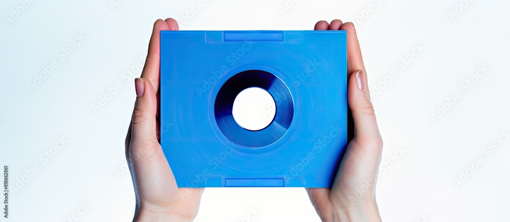 Poster a copy space image of blue floppy a disks being held isolated on a white background showcasing their