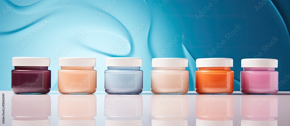 Fototapete jars of body cream displayed on a colorful background providing an appealing copy space image