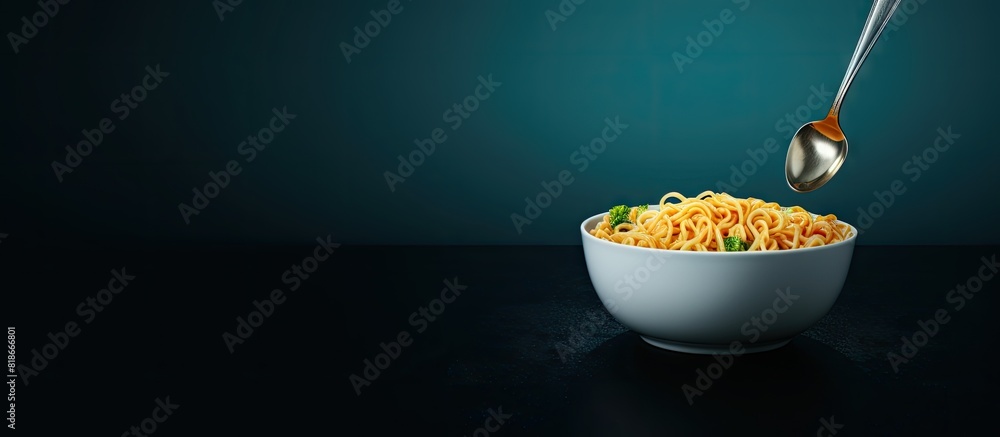 Poster A fork holds instant noodles on a dark blue bowl while copy space is available on the left side of the image