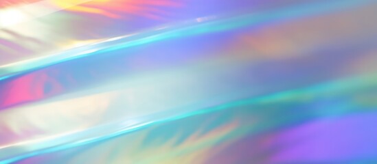 Obraz premium The image is an abstract iridescent background with a soft focus. The colors are pastel shades of pink, blue, and green. The image has a dreamy, ethereal quality.