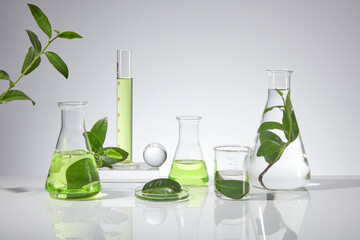 Various types of laboratory instrument displayed on white texture including erlenmeyer flask,...