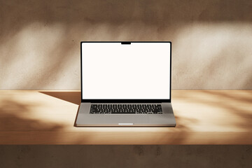Apple MacBook Pro on the wooden desk on a plaster background