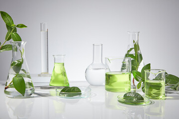 Advertising photo of green tea and laboratory utensils with many items of experiment placed on...