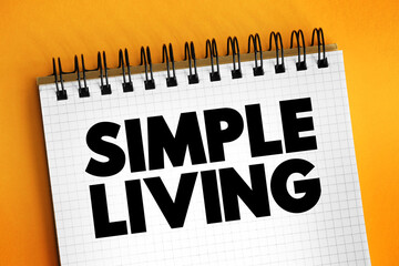 Simple Living - practices that promote simplicity in one's lifestyle, text concept on notepad