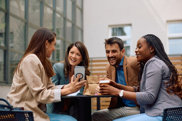 Happy start up team having fun while relaxing on patio in  office.