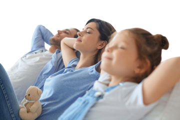 Relaxed young family resting and dreaming about new home on comfortable sofa together on a transparent background