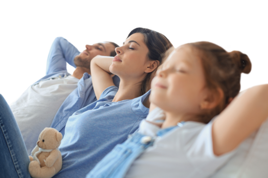 Relaxed young family resting and dreaming about new home on comfortable sofa together on a transparent background