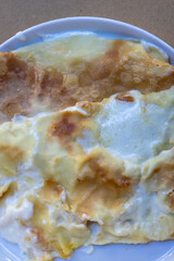 Close up shot from above of a plate of Focaccia Di Recco, typical Italian and Ligurian dish, a...