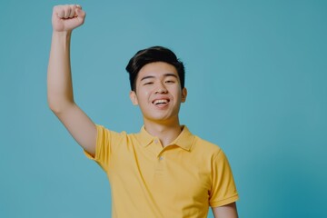 Fototapeta premium Indian man with fist in studio portrait for winning mindset, enjoyment, or achievement. Male student, young model, or celebration with pleased, excited face or achievement.