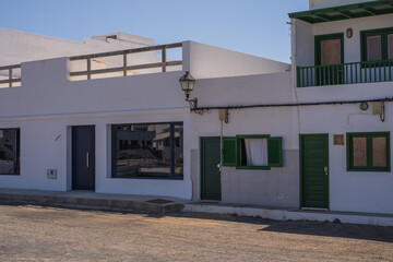 Typical white houses of the village of Caleta de Caballo. Dirt street. Lanzarote, Canary Islands, Spain