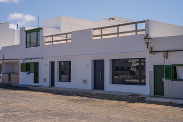 Typical white houses of the village of Caleta de Caballo. Dirt street. Lanzarote, Canary Islands, Spain