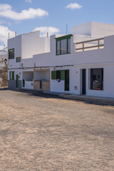 Typical white houses of the village of Caleta de Caballo. Dirt street. Lanzarote, Canary Islands, Spain