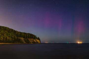Baltic cliff in Gdynia Orlowoat night with Northerm lights over the sea. Poland