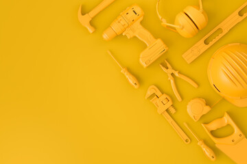 Top view of monochrome construction tools for repair on multicolor background