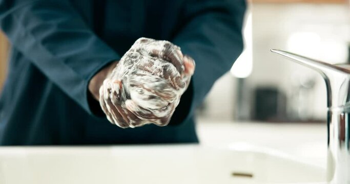 Black man, hands and washing with soap by sink for hygiene, disinfection or sanitizing in bathroom. Closeup of African, male person or janitor cleaning for dirt, bacteria or germ removal by faucet