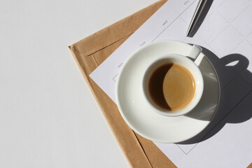 Cup of Espresso Coffee on Daily Planner List and Parcel with Papers. Business Planning.