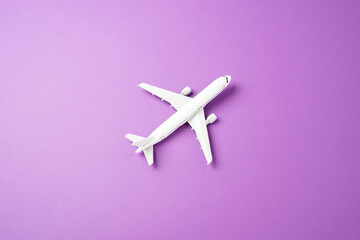 Passenger plane on a purple-pink background. Commercial flights Passenger transportation. Business...