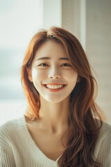 Obraz premium Portrait of a beautiful young asian woman smiling at the camera