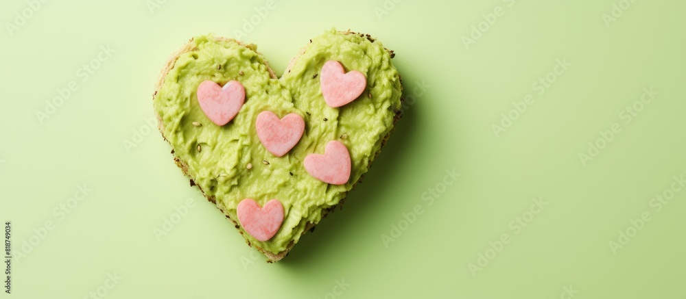 Poster heart shaped green cheese with basilic and avocado paste sandwiches on a pink background ideal for a