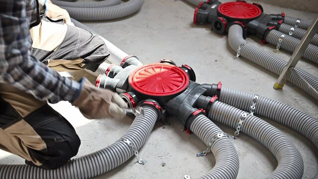 HVAC Technician Working on Modern Air Duct Pipe Inside Newly Developed House. 