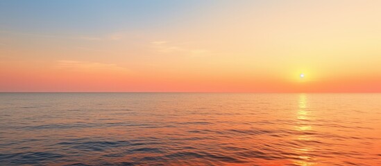 Fototapeta premium A tranquil evening seascape with an orange sea horizon offering a serene and peaceful sea view Perfect as a copy space image