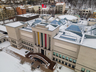 some snow roofs and many buildings in the snow, some with colorful accents