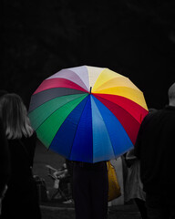 Rainbow umbrella in the shadow in a crowd of people. Pride festival