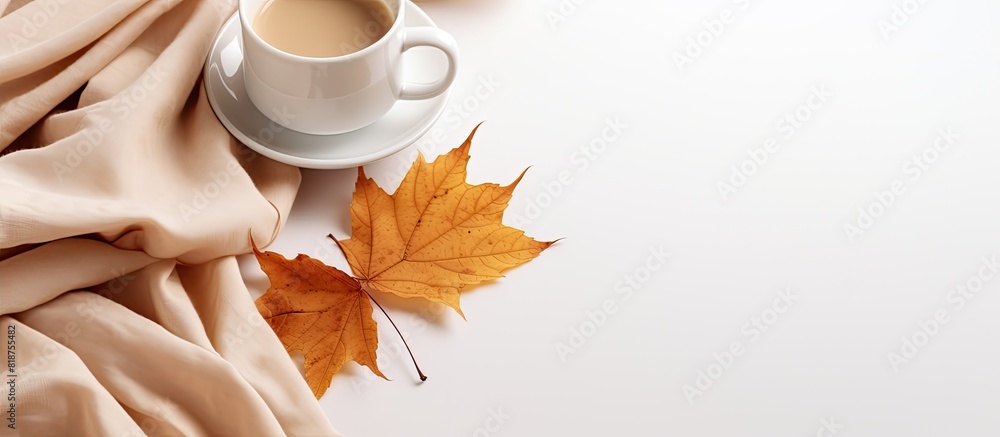 Poster autumn leaves on a white background complemented by a cup of coffee and a cozy green blanket copy sp