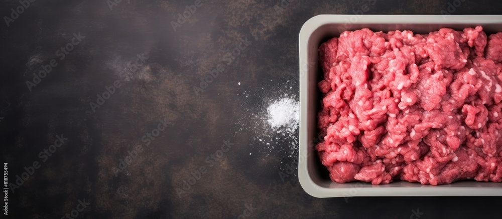 Aufkleber Top view of fresh minced meat in a plastic box packaging tray on a gray stone background The flat lay image includes copy space for text