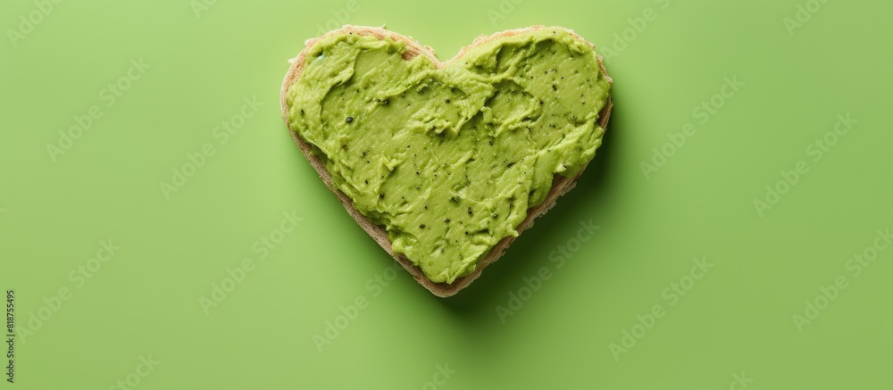Poster heart shaped green cheese with basilic and avocado paste sandwiches on a pink background ideal for a