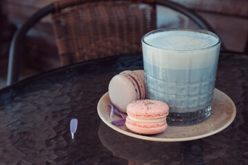 Tasty macaron cookies and blue matcha latte