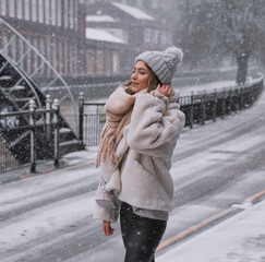 Beautiful woman confidently striding through a snowy street