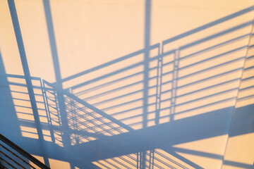 shadow of railing on wall at sunset
