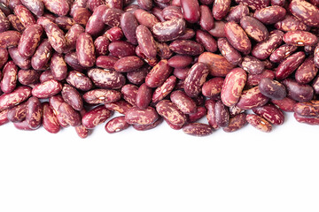 Uncooked, variegated kidney bean seeds border on white background. Copy space for text. Top view