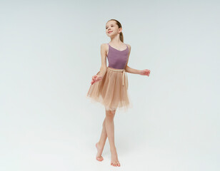 young teenage ballerina girl shows ballet steps in a photo studio