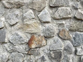 Background of stone wall texture made from variety of stones shape