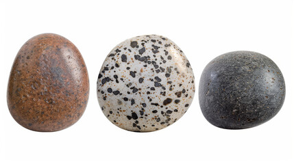 Three rocks of different colors and textures. The first is brown, the second is white, and the third is black