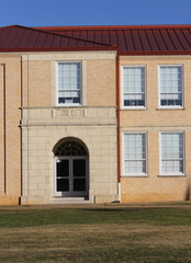 Facade of an Old School Building in New London, TX on a sunny day