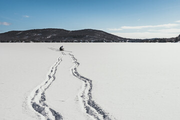Hiking on a frozen lake in Quebec, Canada. Black Mountain Lake