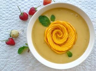 Mango, Pineapple, Passion fruit, Banana and oat coconut milk smoothie bowl topped with fresh mango, kiwi, toasted shredded coconut and pumpkin seeds	
