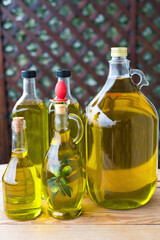 olive oil, extra virgin olive oil in a glass bottle, on a wooden table.
