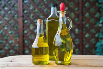 olive oil, extra virgin olive oil in a glass bottle, on a wooden table.