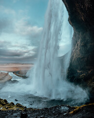 an image of a waterfall in a canyon with water streaming from it