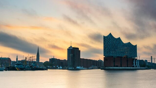 HAMBURG, GERMANY - May. 12th, 2024: time lapse, sunrise at Hamburg harbor with Elbphilharmonie