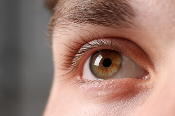 Man with beautiful eyes on blurred background, closeup